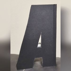 Letter A. Handcut Upcycled from a Black Book
